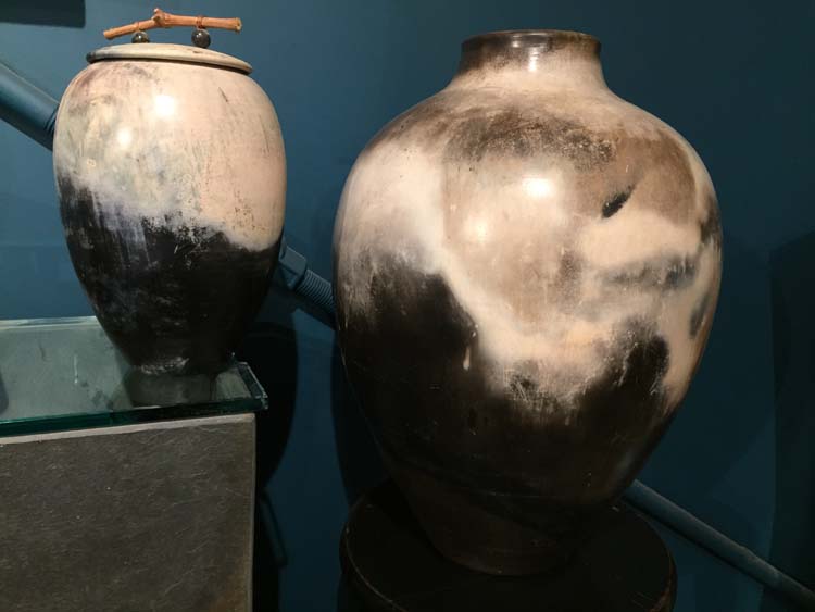 two vases with teal background