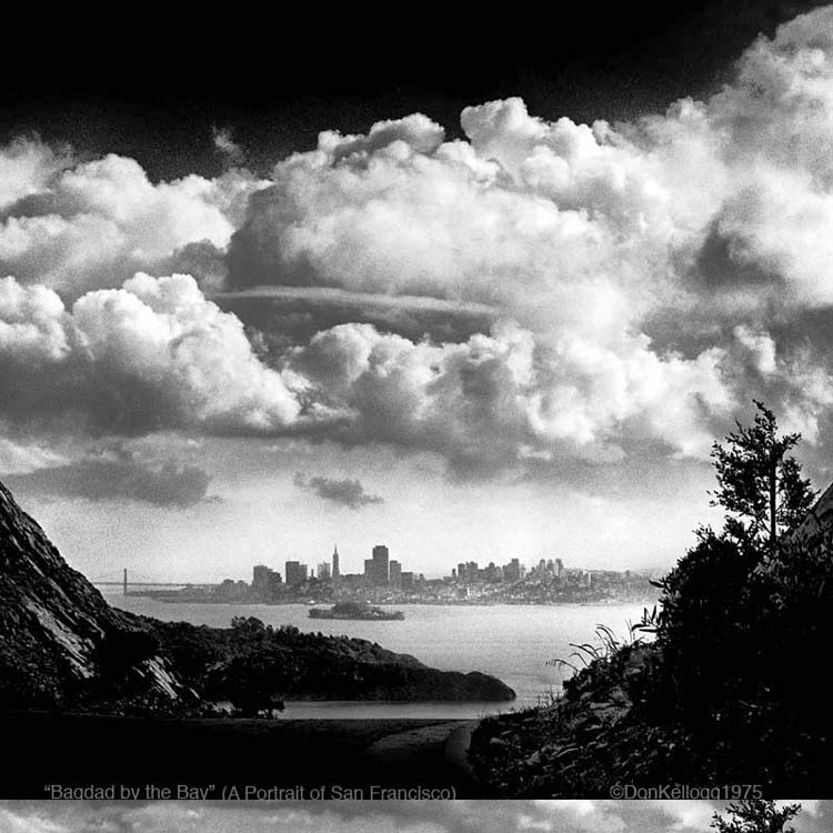black and white photo of clouds and city